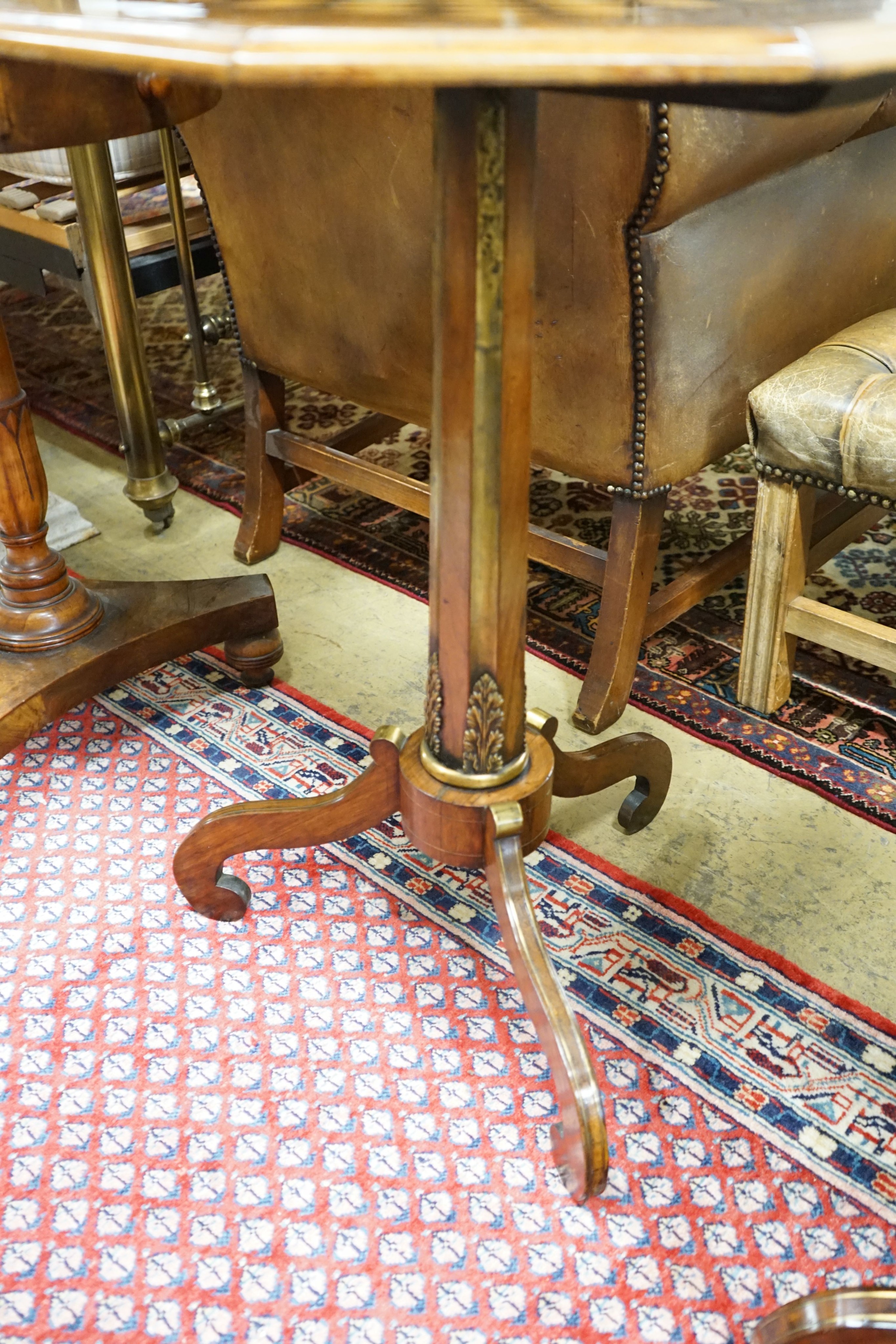 A Regency style brass mounted octagonal rosewood tripod games table, width 52cm, height 72cm